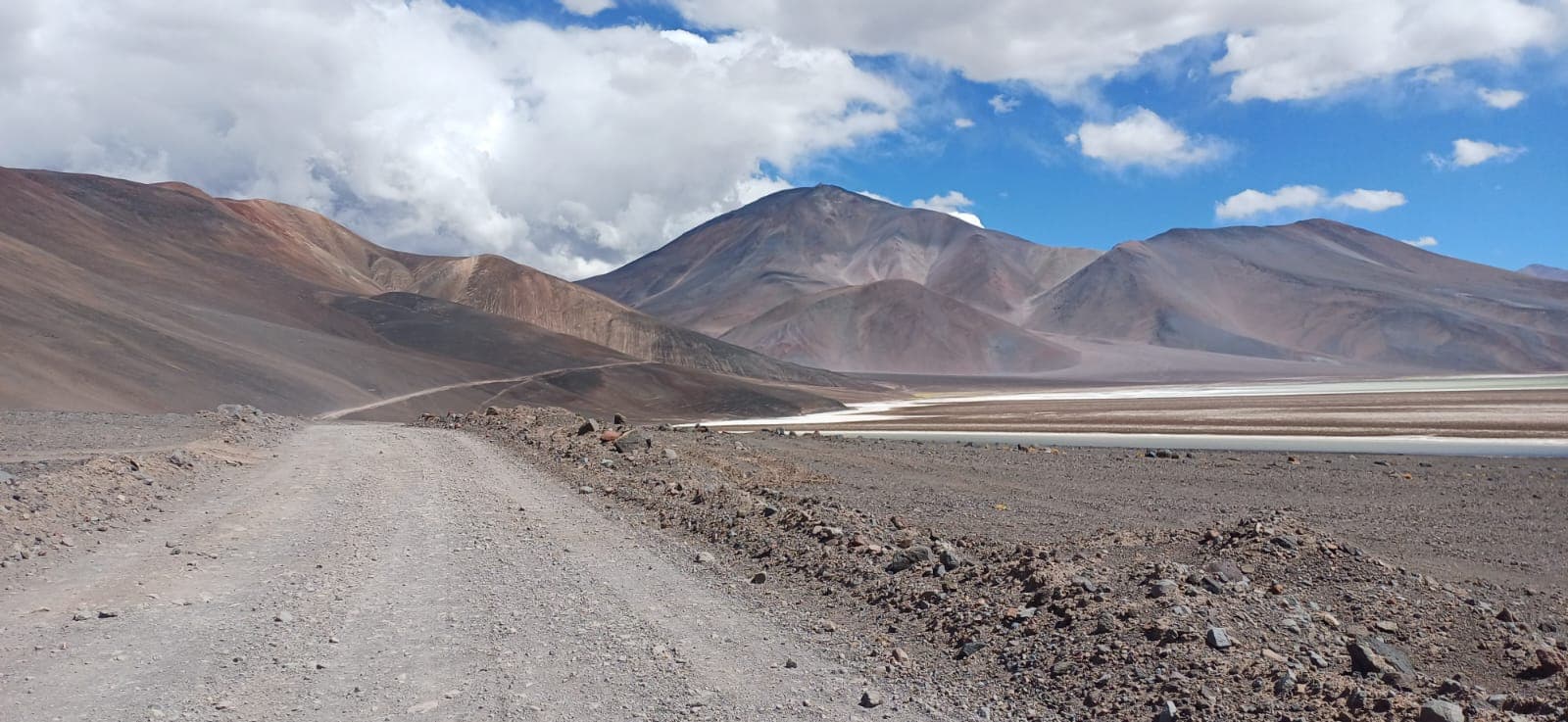 Riders moving along an open route between mountains